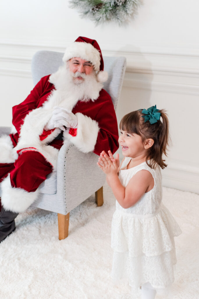 toddler girl excited to see Santa at Christmas Mini Session Miami 