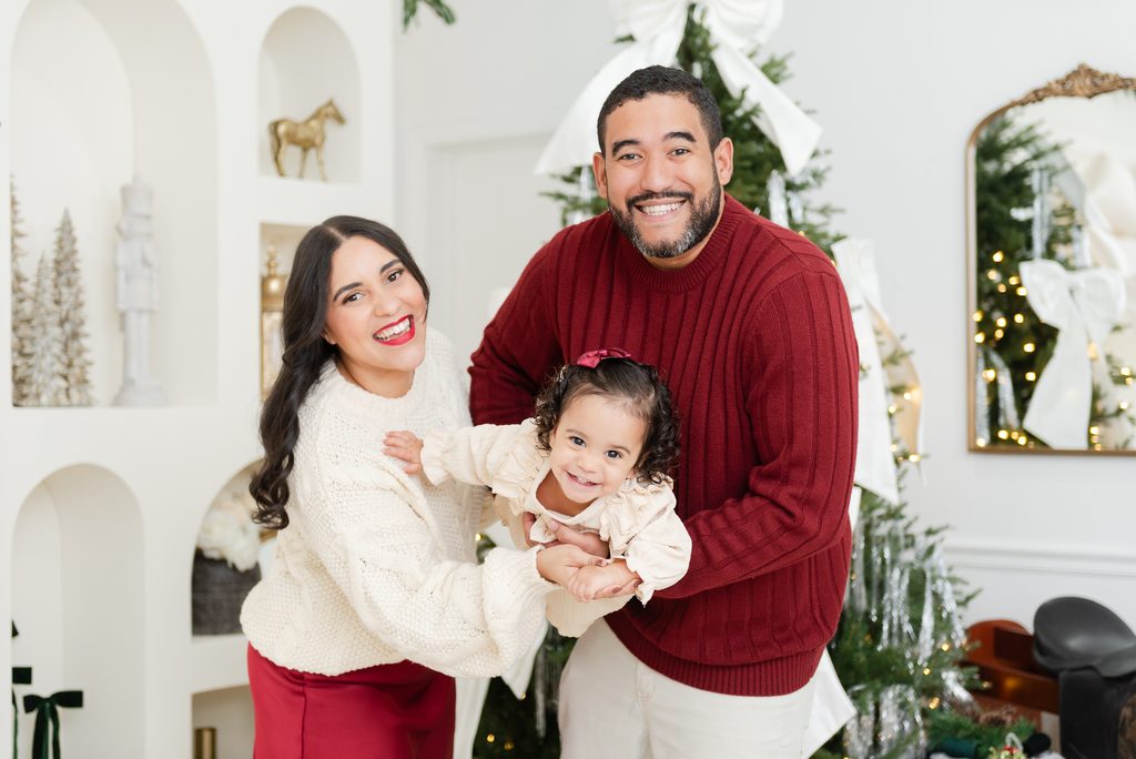 Family of three Christmas photoshoot in Miami playful poses by MSP Lifestyle Miami Family Photographers