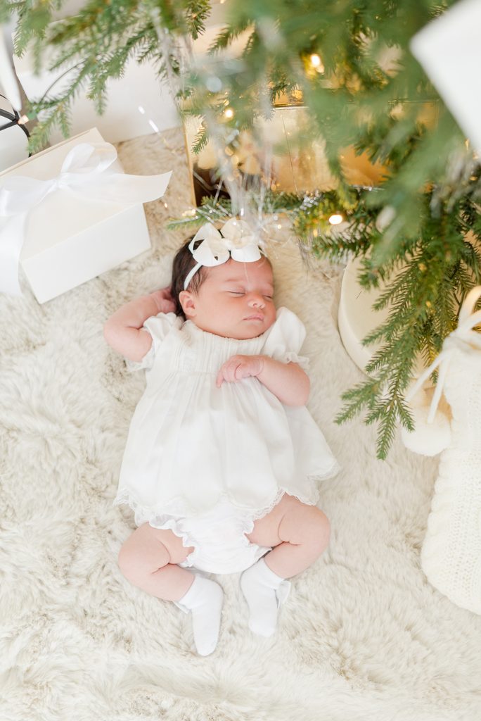 Newborn laying under the Christmas Tree by MSP Lifestyle Miami Family Photographers
