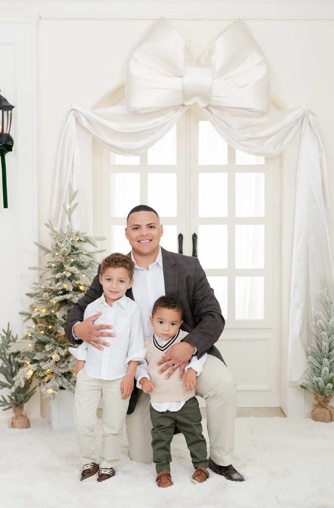 Dad with two kids at a Christmas Photoshoot in Miami, editorial bellman photos in Miami playful poses by MSP Lifestyle Miami Family Photographers